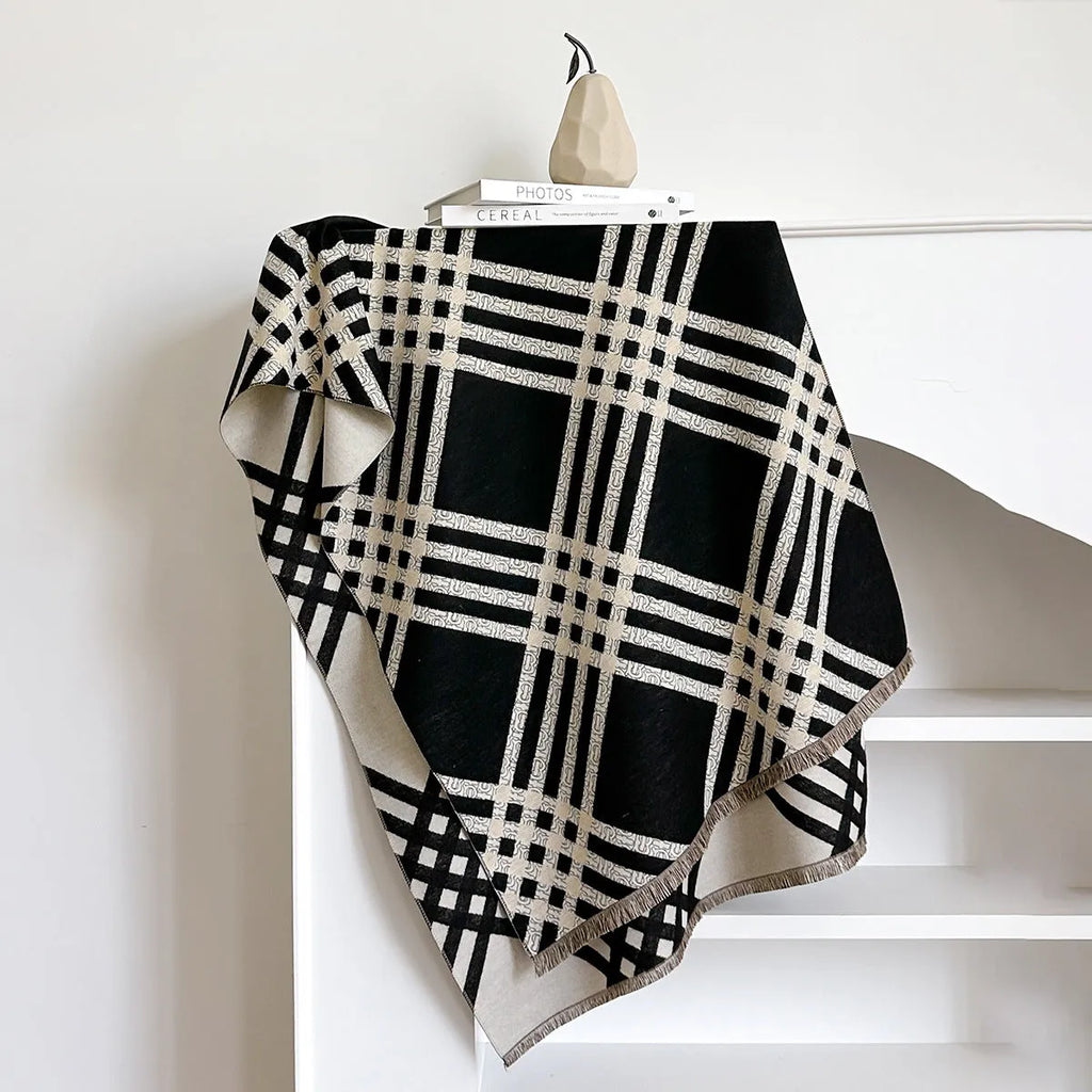 Mid-length brown cashmere-like scarf with tassel ends laid flat.