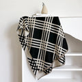 Mid-length brown cashmere-like scarf with tassel ends laid flat.