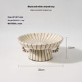 Black and white striped retro synthetic resin dessert plate on a table.
