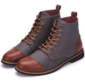 A pair of large black leather motorcycle boots featuring silver buckle details and a thick rubber sole.