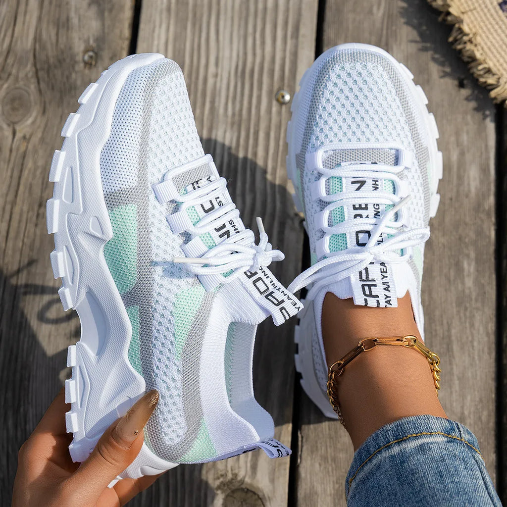 Women's Flyknit mesh lace-up sneakers in a multi-tonal colour with a flat rubber sole.