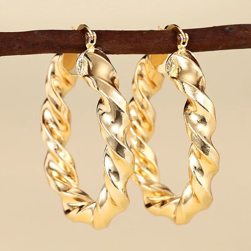 Geometric drop-shaped ear clips with ring and line design in metallic finish