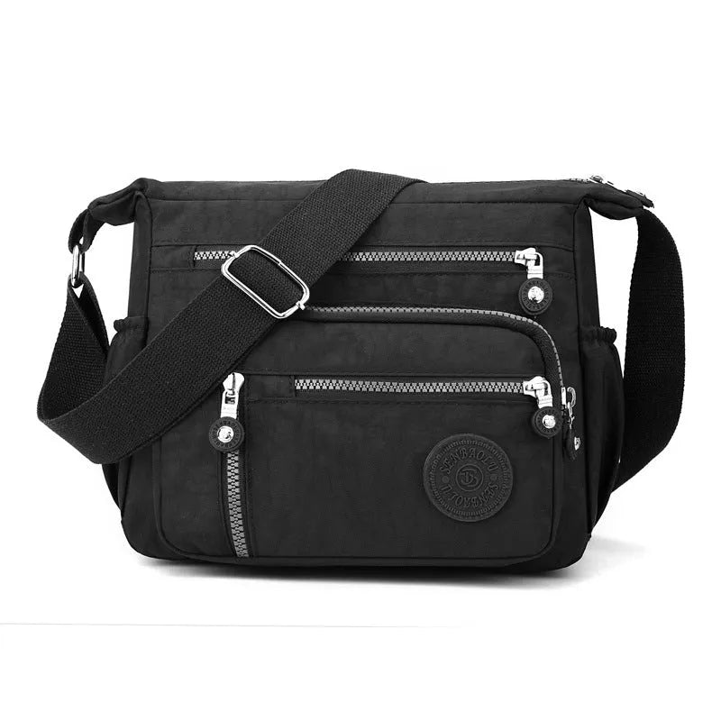 Grey soft nylon messenger bag with single shoulder strap showing square vertical shape