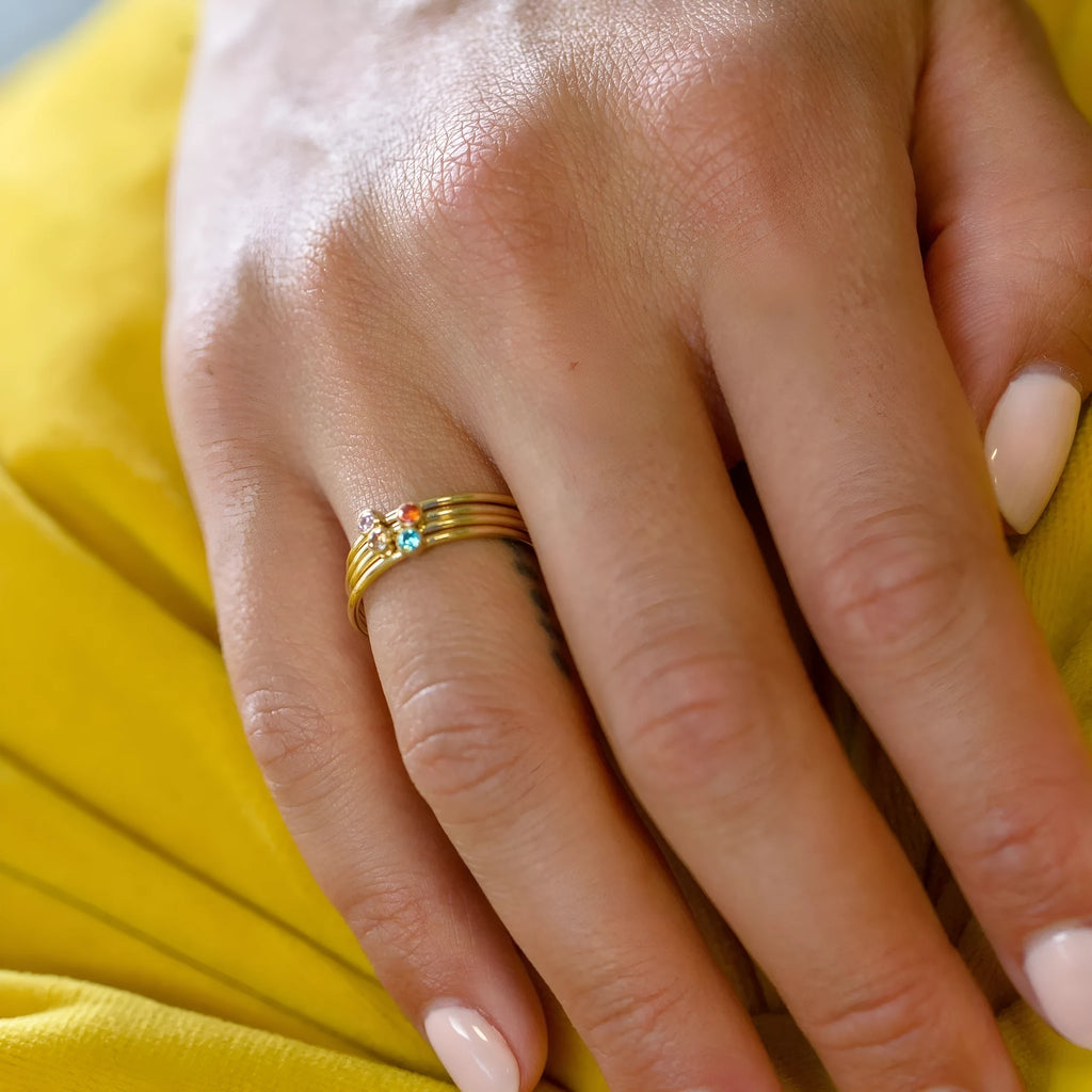 December colour birthstone engraved titanium steel ring with geometric shape on a plain background