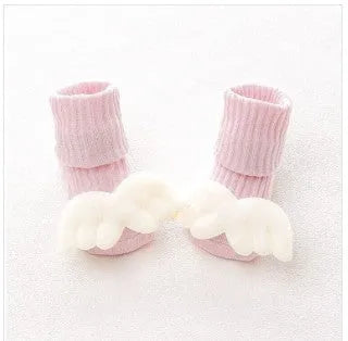 Cotton baby floor socks in various designs including blue bow and lion, showing sizes for infants 0-3 months