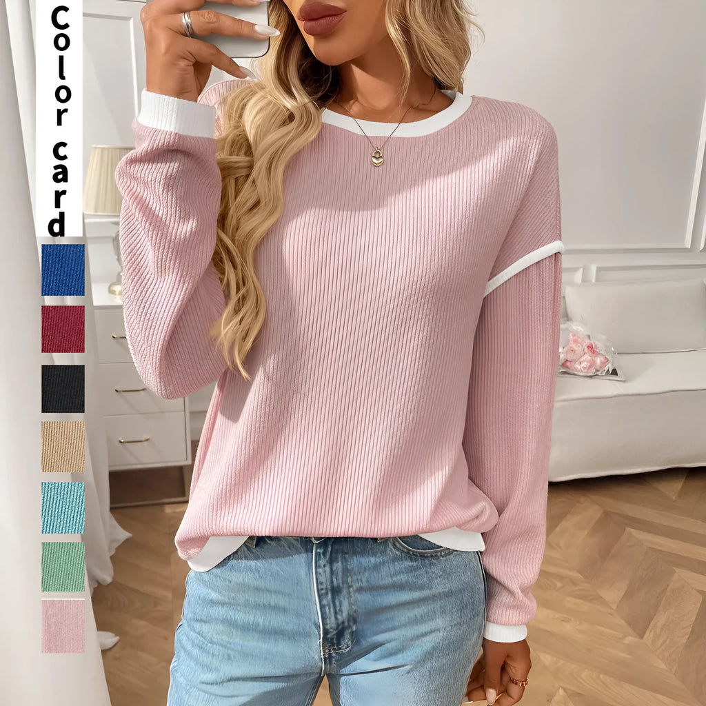 Loose women's round neck long sleeve polyester pullover top on a hanger