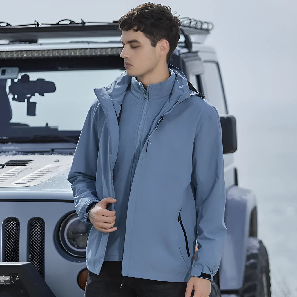 Men's fluorescent coloured removable waterproof mountaineering suit with thick padding shown on a model.