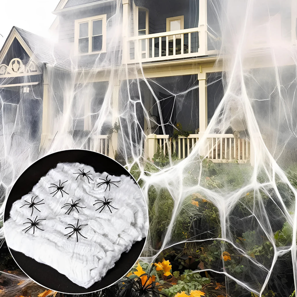White cotton Halloween spider web decoration with plastic spiders on dark background