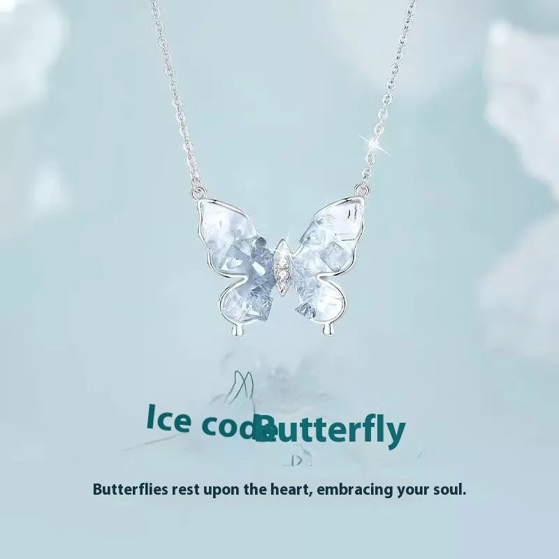 Close-up of a silver butterfly pendant necklace on an adjustable O-ring chain.