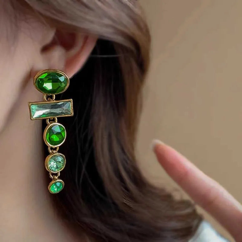 A pair of women's green gradient alloy drop earrings with a geometric tassel design and inlaid zircon stone.