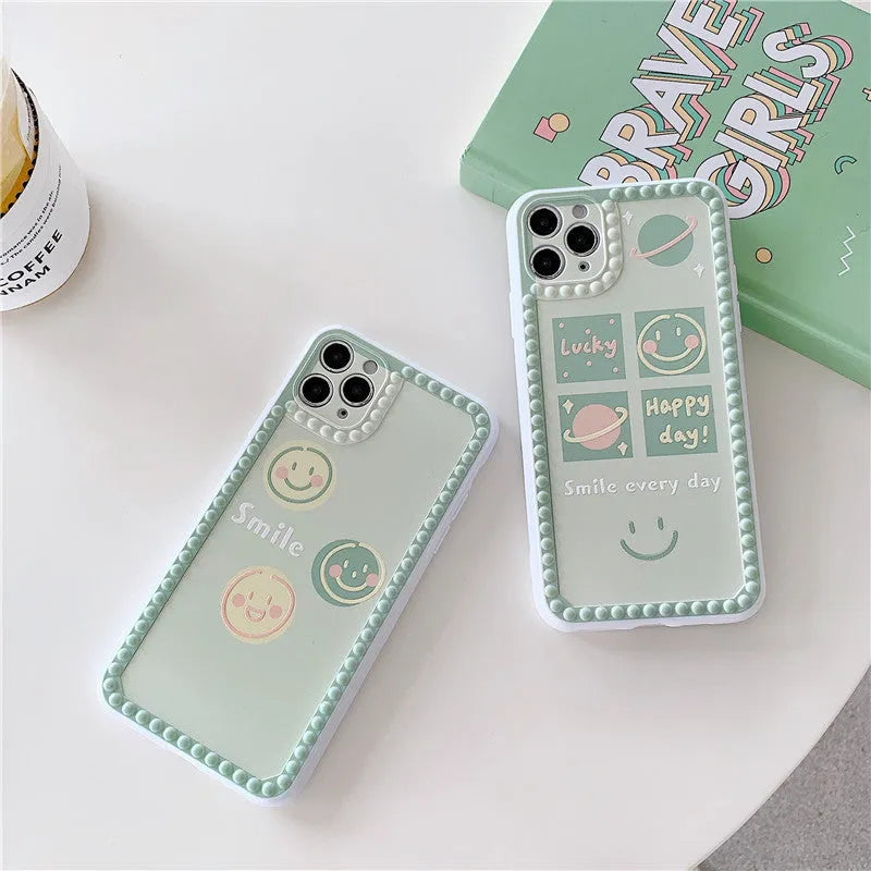Green TPU iPhone case with geometric smiley face and polka dot design on a simple back cover.