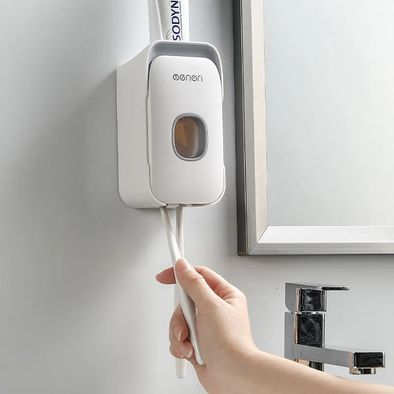 Automatic toothpaste dispenser unit mounted on a bathroom wall in blue colour.