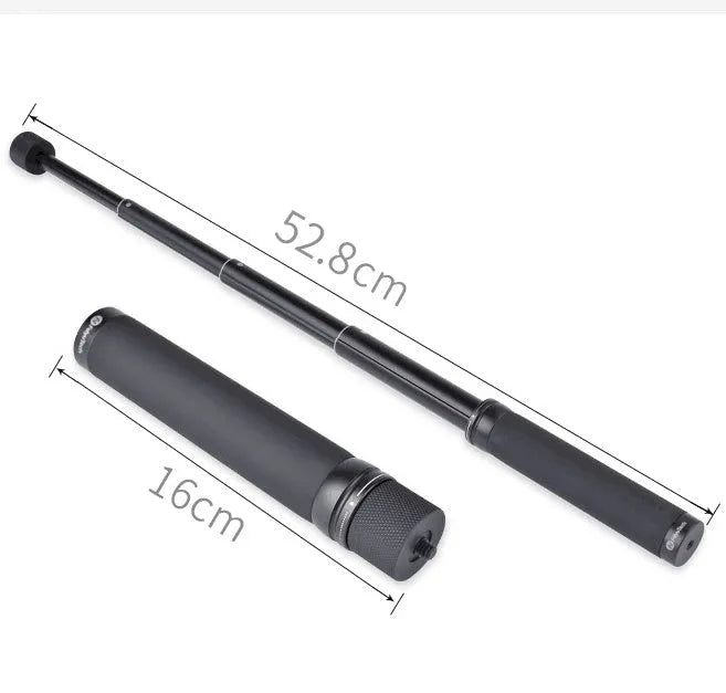 Black retractable selfie stick extended with phone in holder and visible wrist strap.