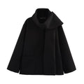 Women's long black polyester coat with a faux fur collar, shown in a street fashion style.