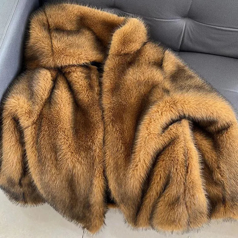 Loose mid-length silver grey artificial fur coat for women on a hanger