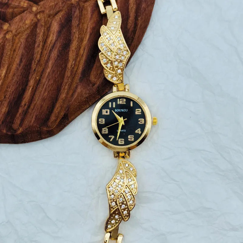 Women's stainless steel watch with round dial and vachette clasp, shown in gold colour.