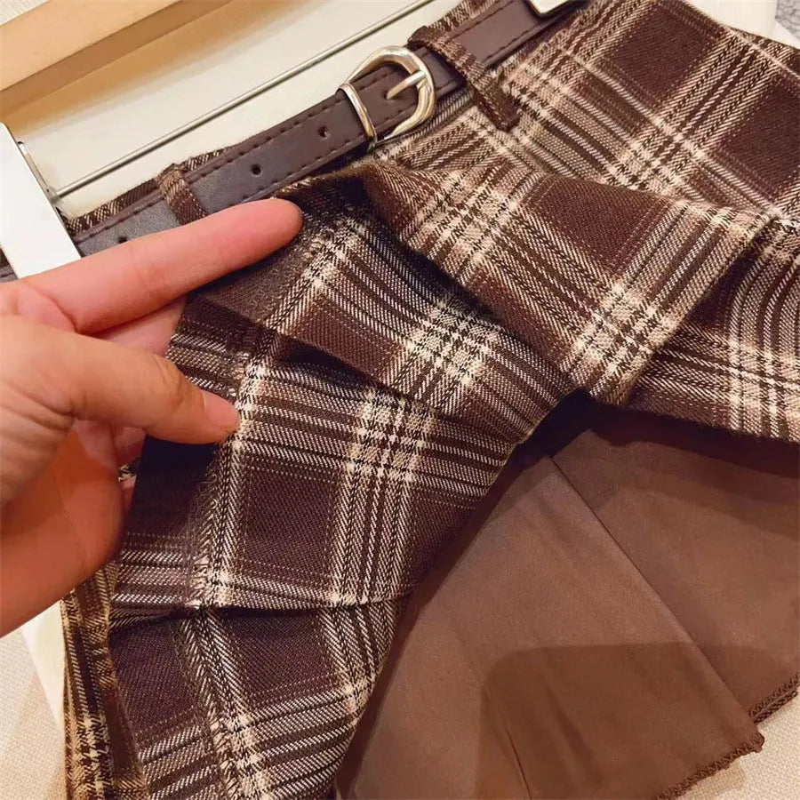 Girls plaid pleated A-line skirt in cotton-blend fabric on a hanger.