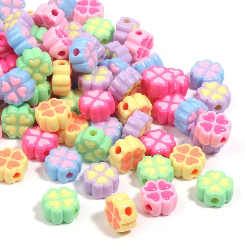 Acrylic clover craft beads with frosted finish in mixed colours including pink, blue and green