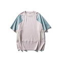Man wearing a loose-fit patchwork contrast colour short sleeve cotton blend sports t-shirt.
