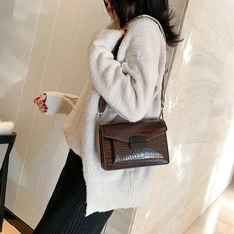 Vintage PU leather crossbody bag in black, shown with adjustable strap.