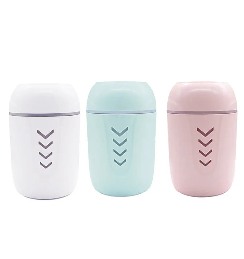 Blue X3 portable columnar humidifier with USB cable on a car dashboard.