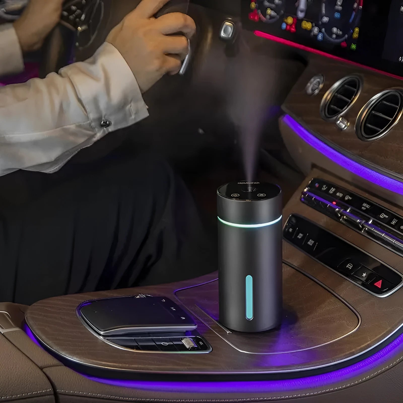Compact aluminium car humidifier and essential oil diffuser with night light on a desk.