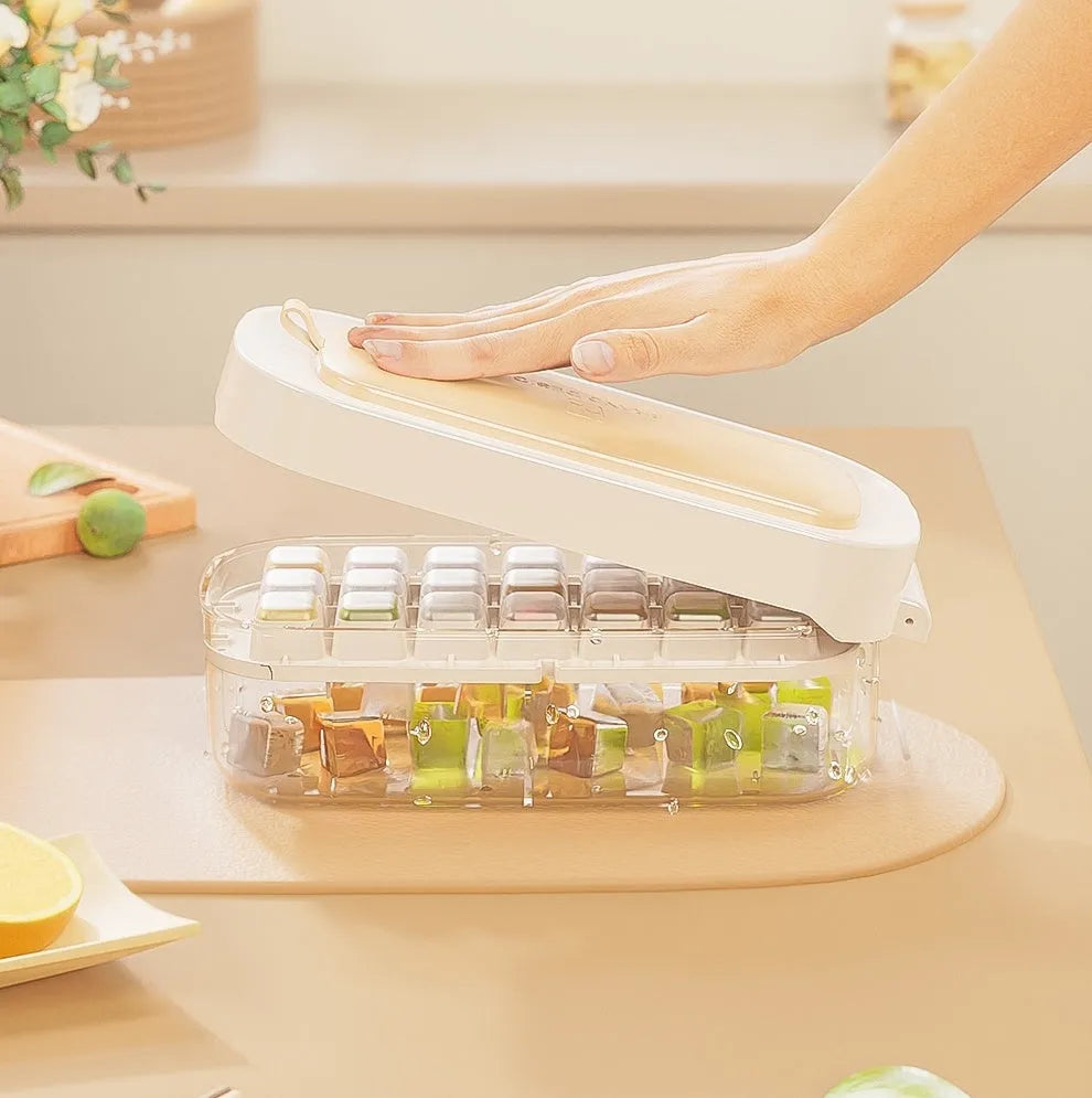 Ice cube tray with grid design and attached ice shovel stored in dedicated compartment