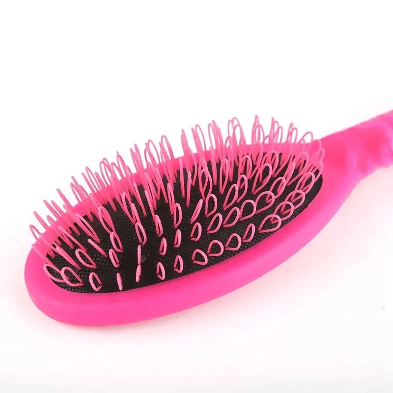 Black and pink plastic hair extension comb with ring teeth and an airbag, measuring 22cm by 6cm