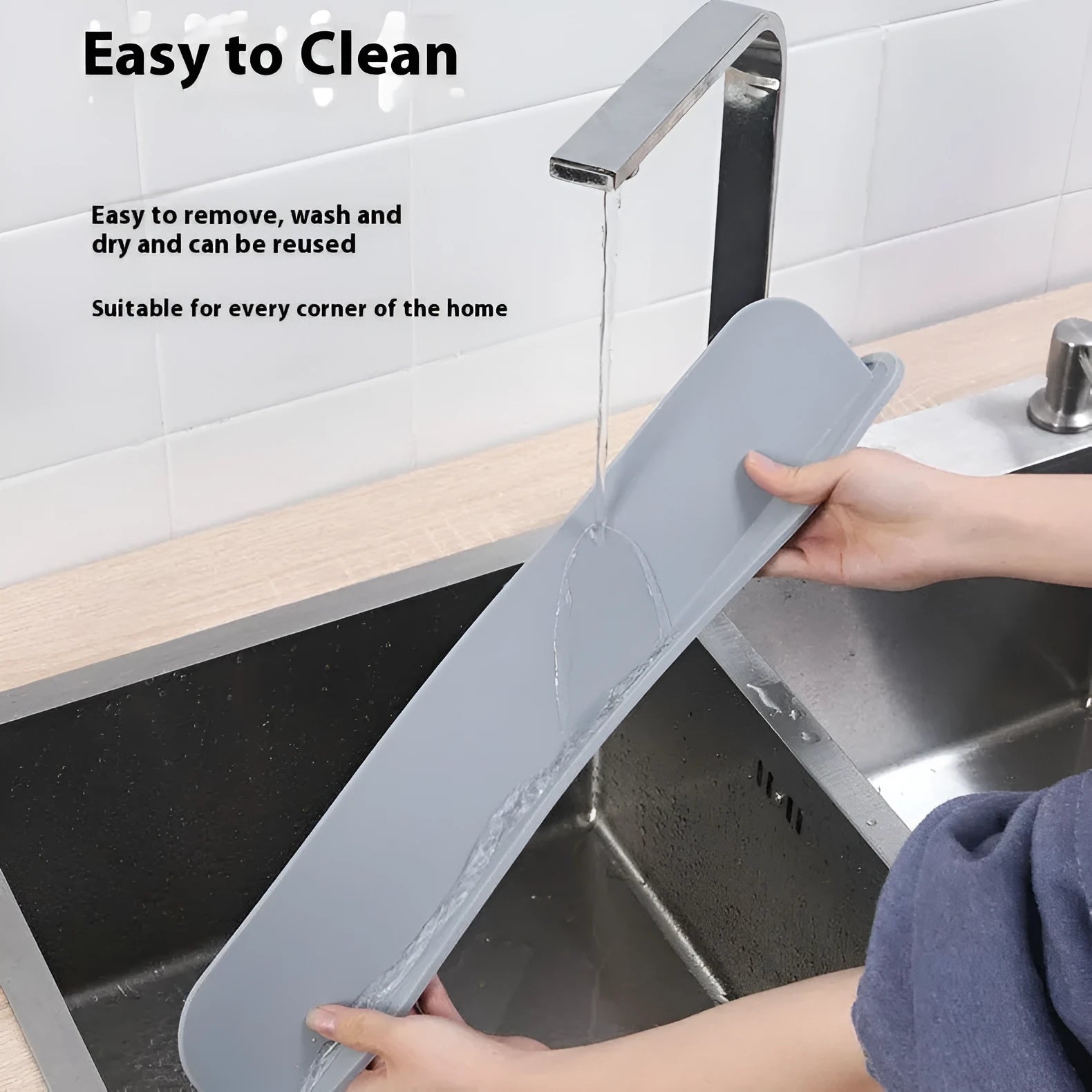A thick grey silicone water blocking plate for a kitchen sink, shown next to a sink edge.