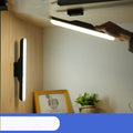 Modern white rechargeable LED desk lamp with touch control on a wooden desk.