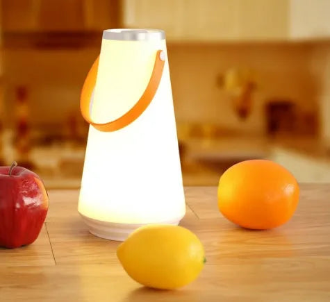 White rechargeable LED bedside lantern with warm light, shown next to a USB charging cable.