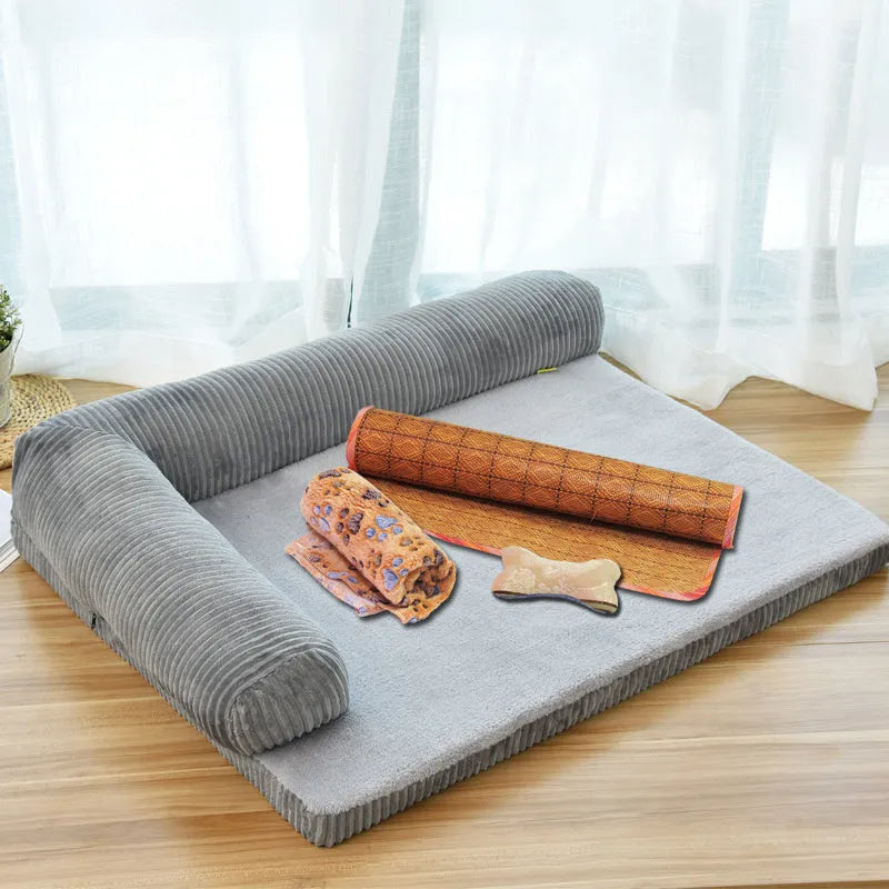 Corduroy dog sofa bed with bolster sides in a grey colour, shown on a wooden floor.