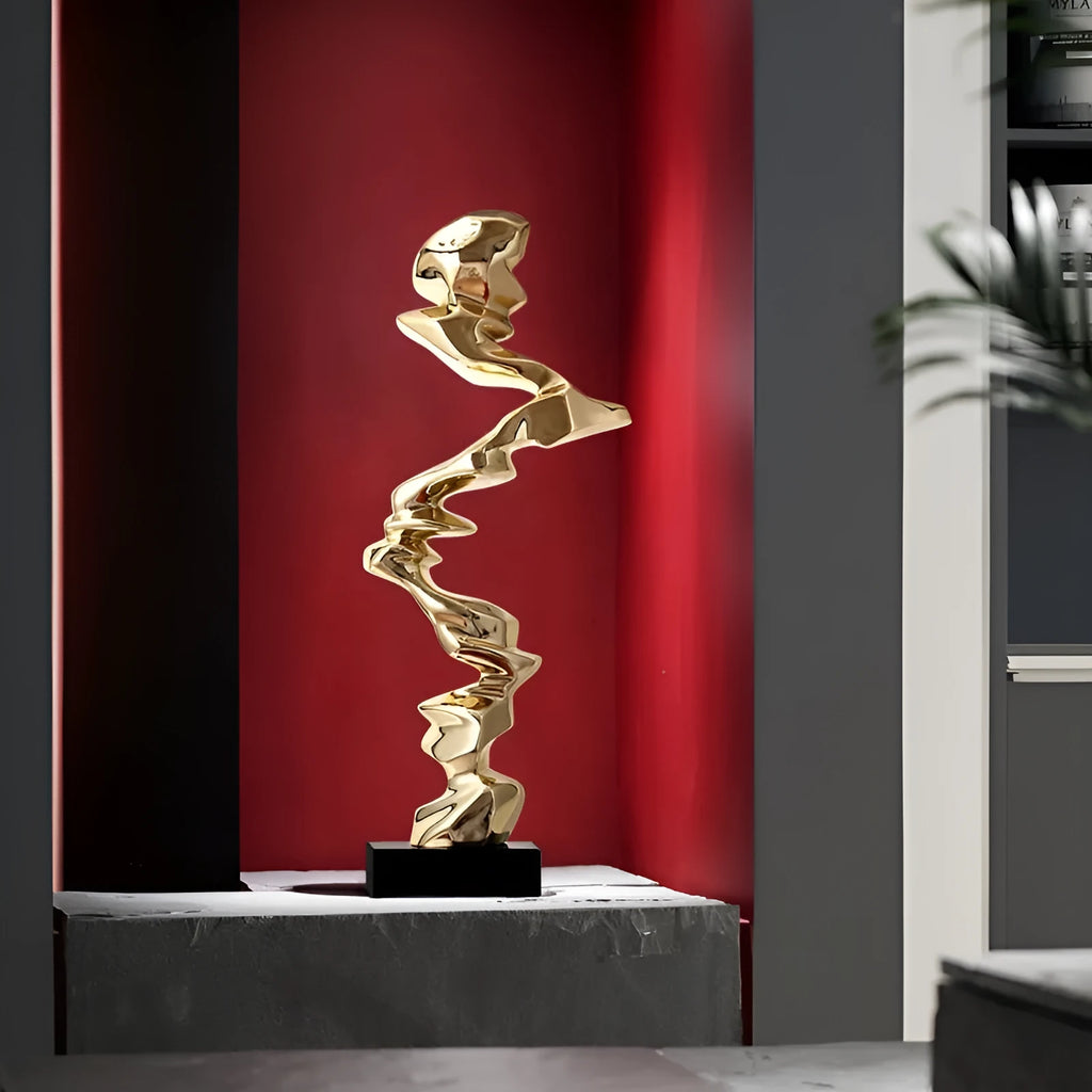 Modern abstract still life ornament in natural resin, shown in bright gold, elegant silver, and phantom blue finishes.