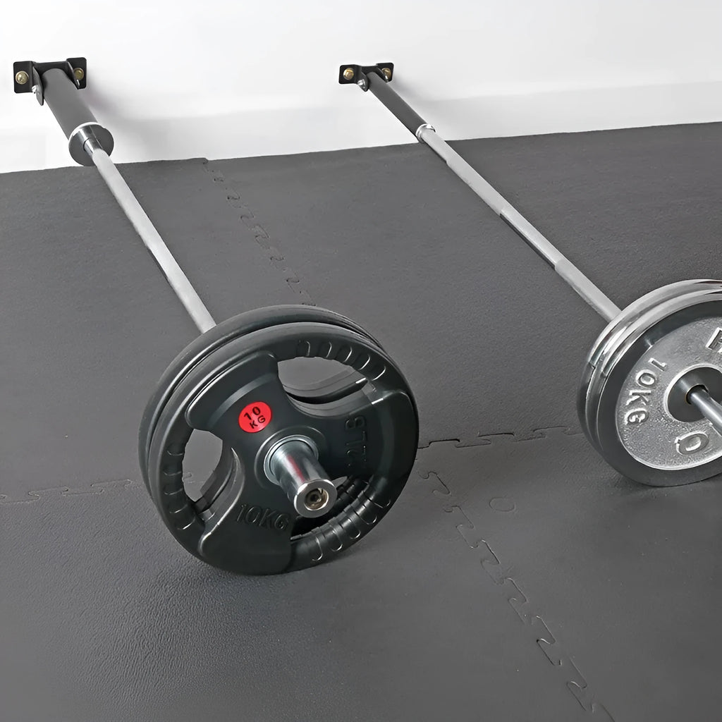 Steel wall-mounted rack holding multiple vertical barbell rods on a garage wall.