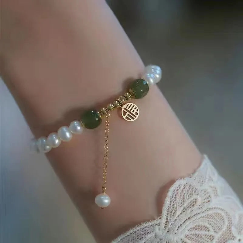 Chinese style handmade glass bead bracelet with bamboo joint elements on a white background.