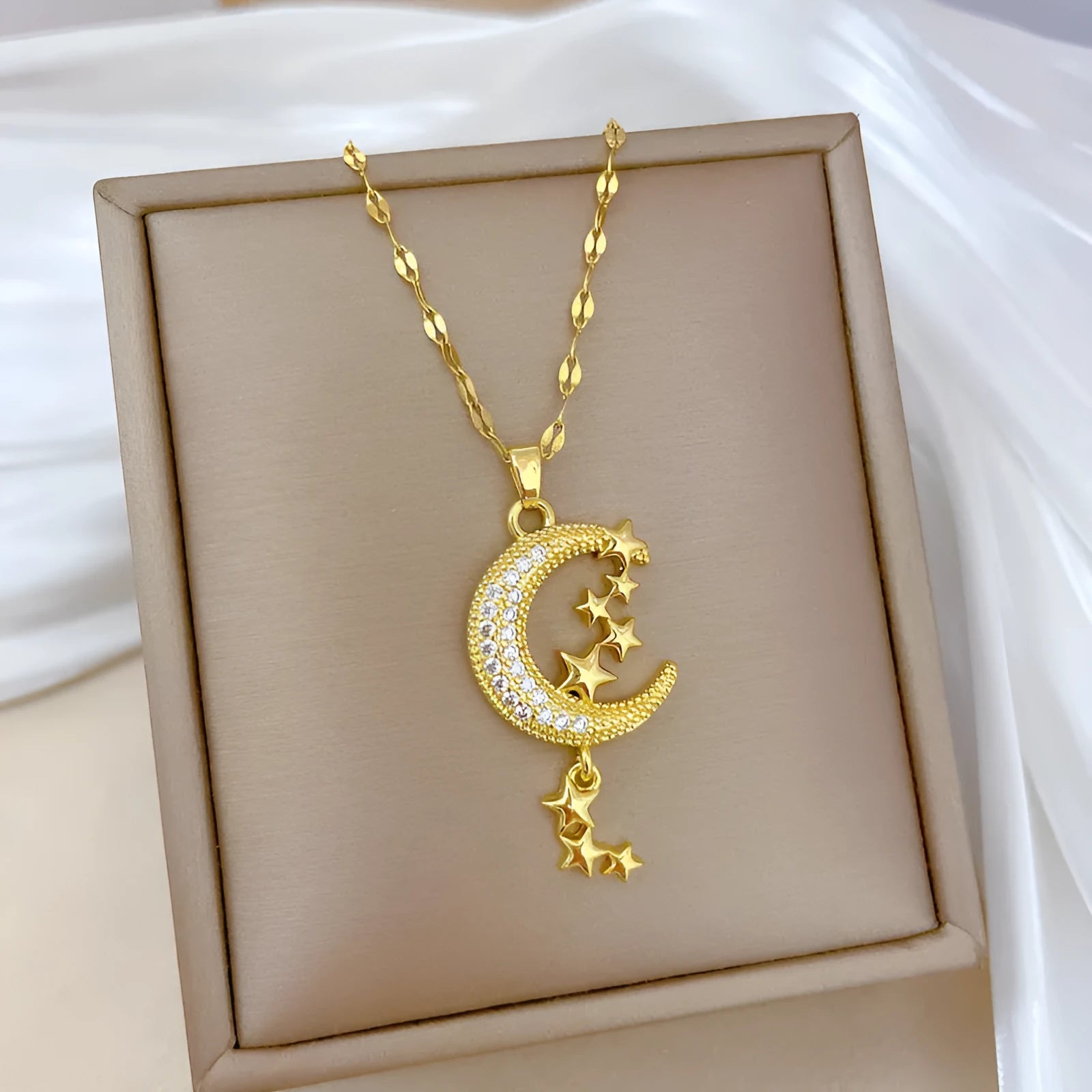 Geometric moon pendant necklace with diamond accents and tassel on stainless steel chain