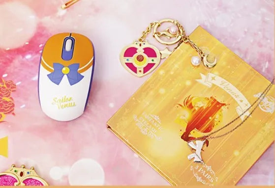 Sailor Moon pink wireless optical mouse with USB receiver on desk