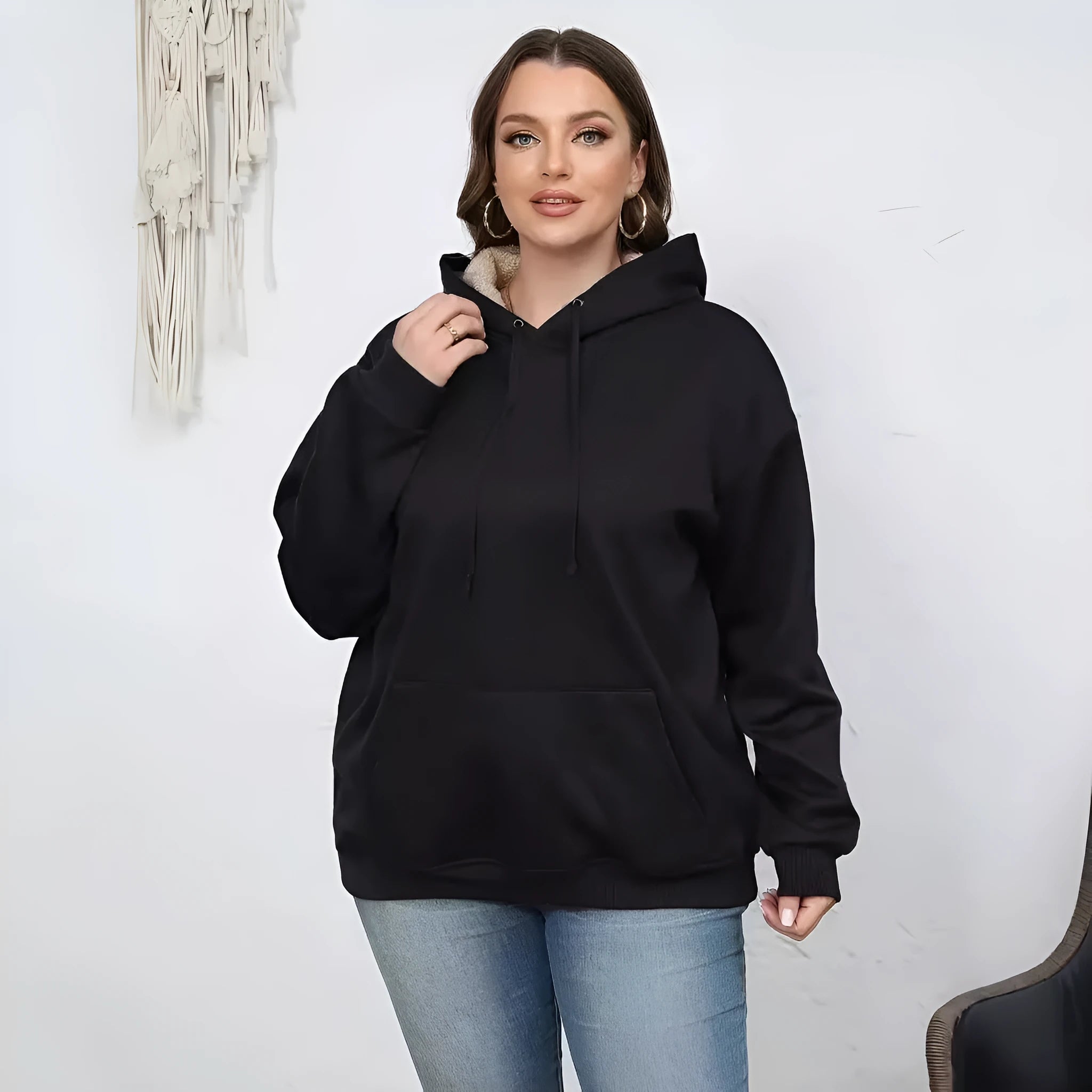 Women's loose fit grey hooded sweatshirt with a 3D textured pattern and a front pocket.