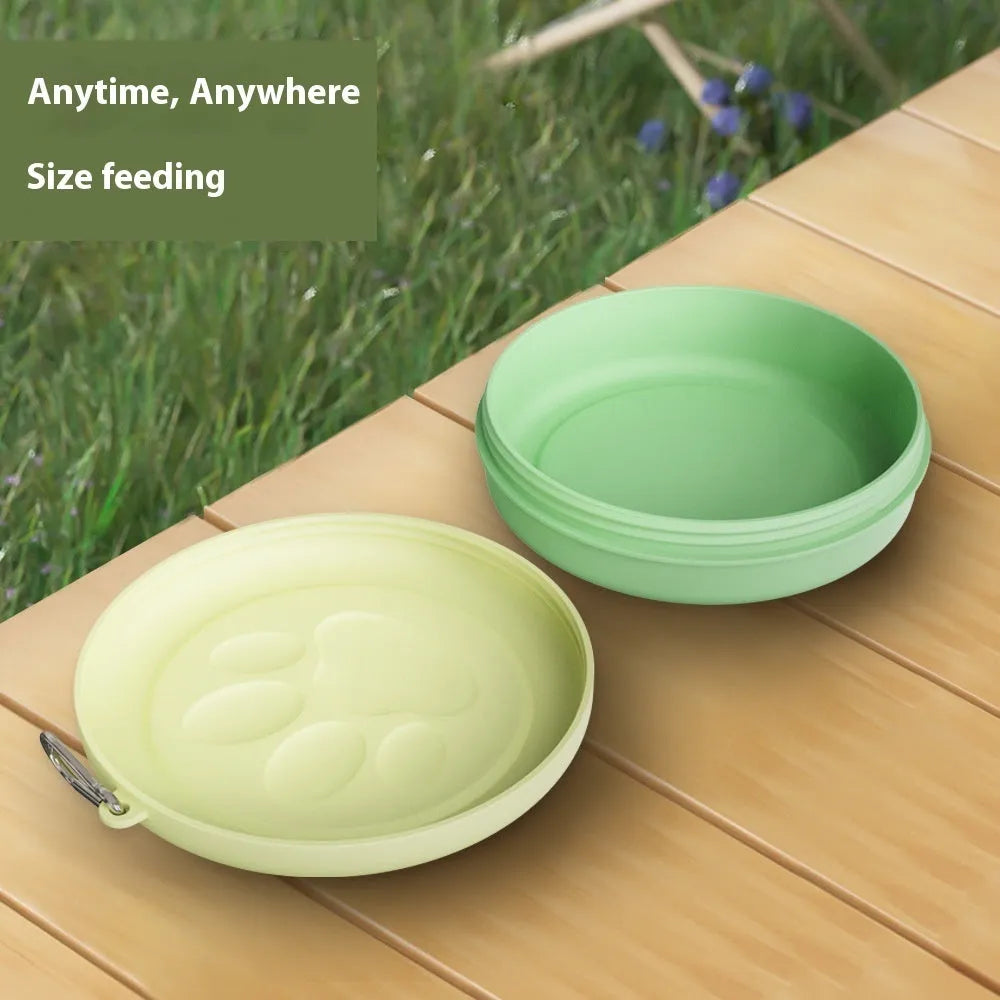 Portable dog bowl in light green colour shown on grass for outdoor feeding