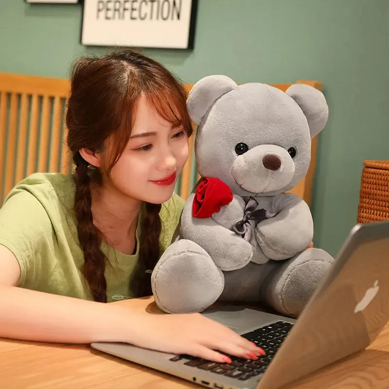 Rose bear plush toy in beige, brown, or grey, shown in sizes from 23cm to 45cm.