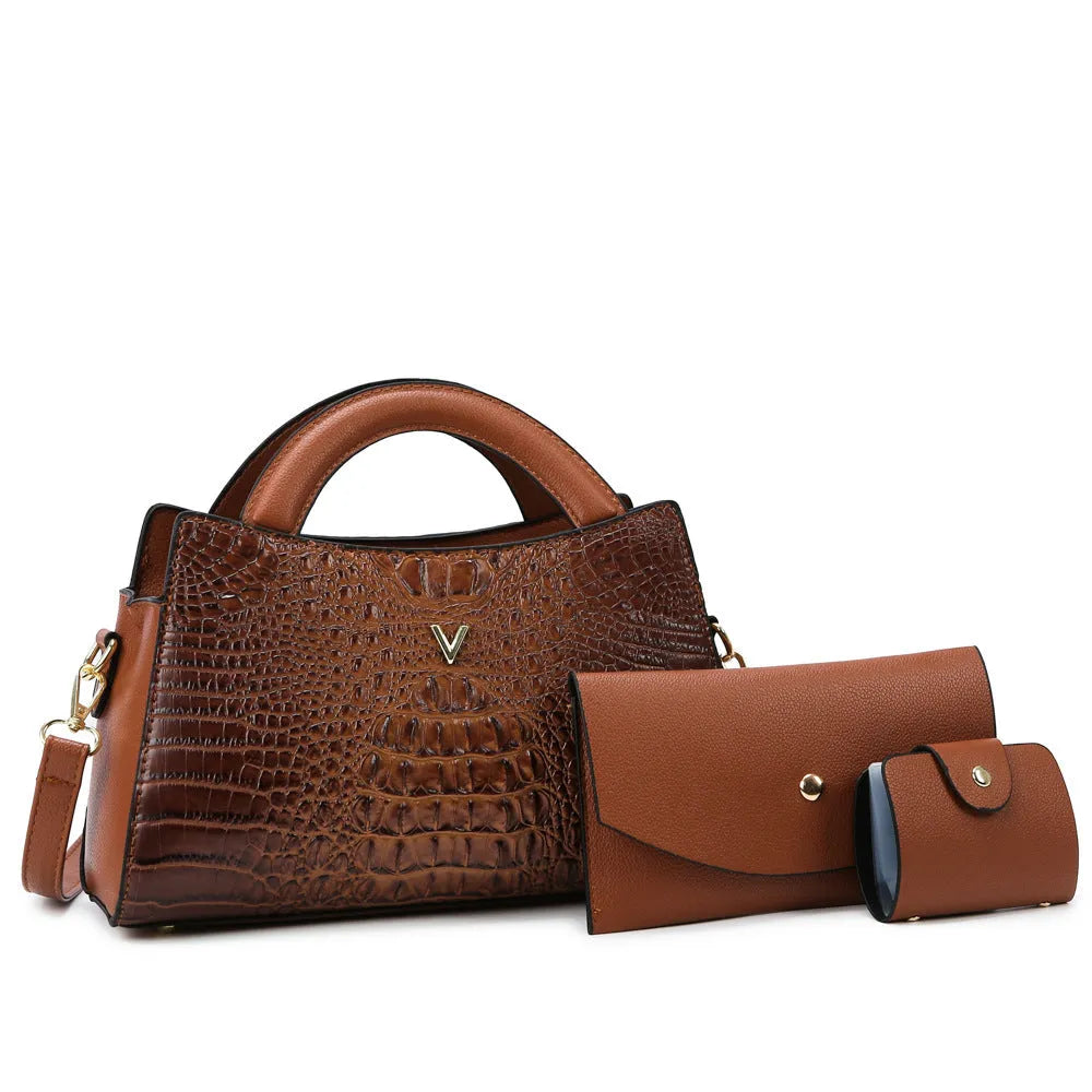 Women's square black crossbody handbag with crocodile pattern texture, showing front zip and adjustable strap.