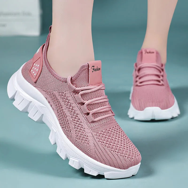 Women's white Flyknit sneakers with thick PVC sole and lace-up front.