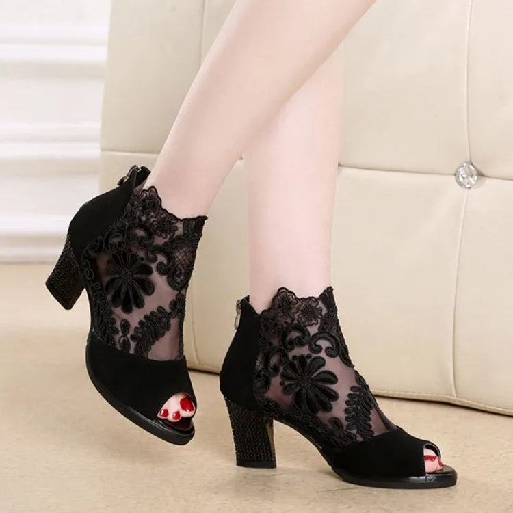 Black women's gladiator sandals with floral lace upper, square high heel, peep toe, and zip closure.