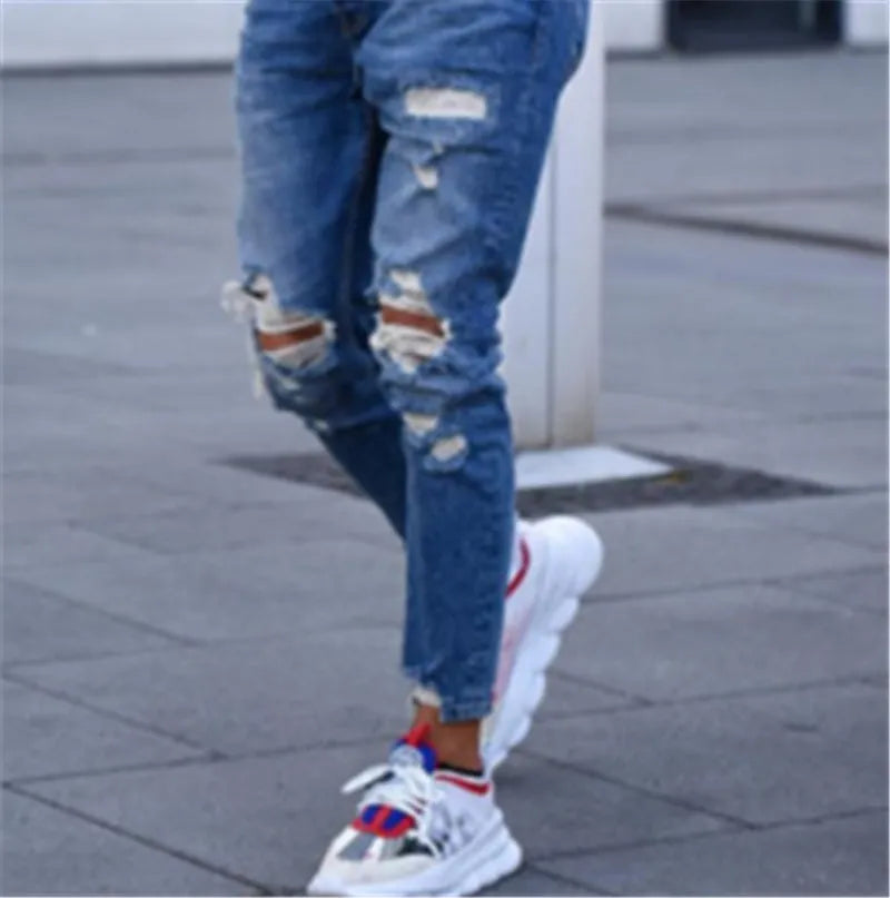 Men's deep blue cotton jeans with distressed hole detailing showing loose fit and six size options