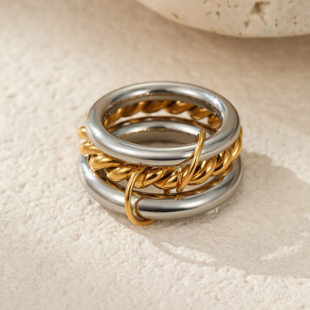 Gold plated stainless steel stacked ring set in three colour variants on a hand.