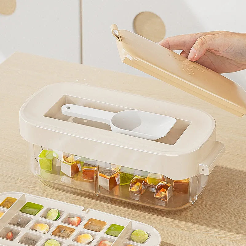 Ice cube tray with grid design and attached ice shovel stored in dedicated compartment