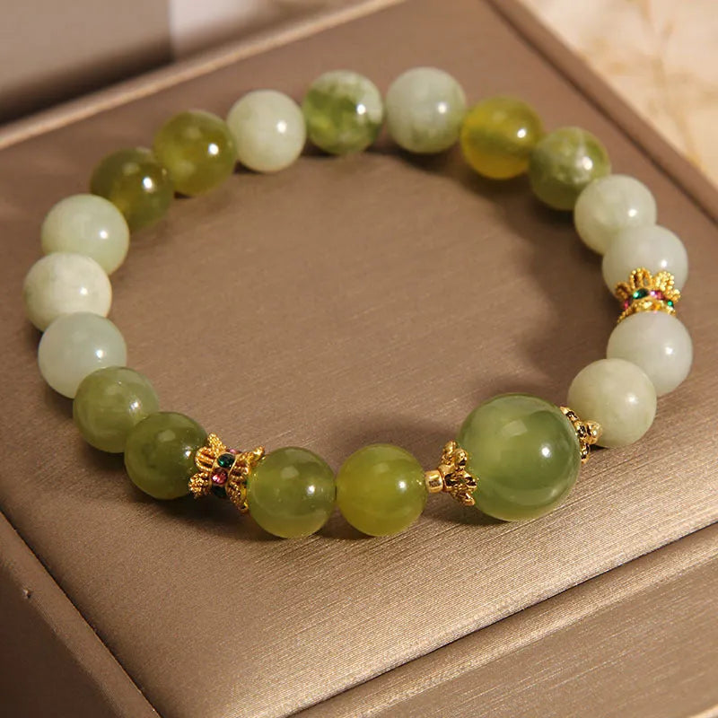 Xiuyan jade green women's bracelet with original design on a wrist.