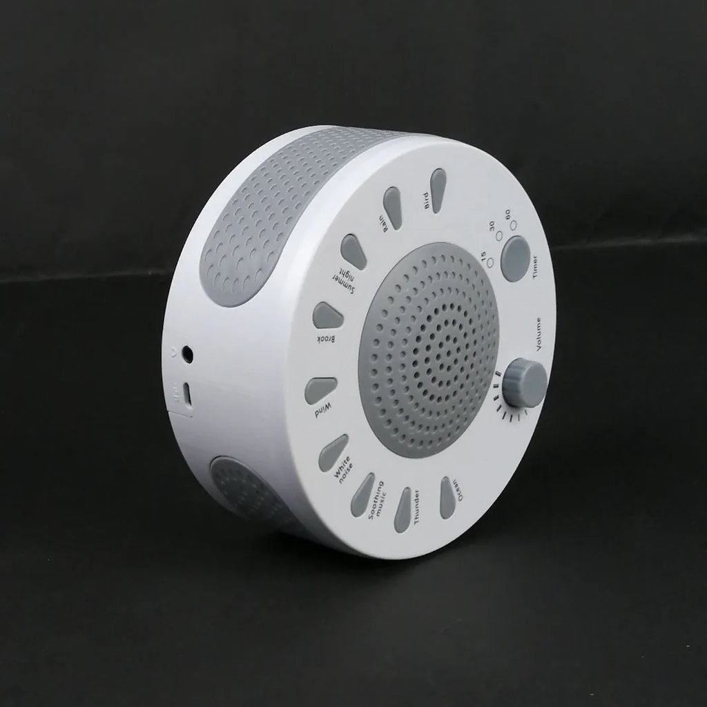 White noise sleep machine with volume knob and timer buttons showing compact portable design