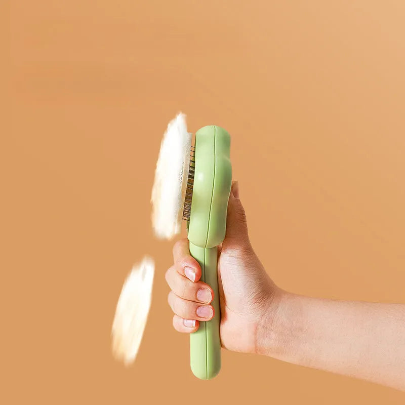 Green or yellow self-cleaning cat comb with stainless steel teeth, showing 20cm length.