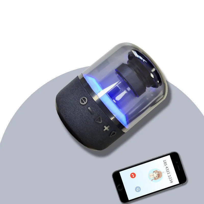 Black wireless Bluetooth speaker with LED lighting and touch controls showing four colours